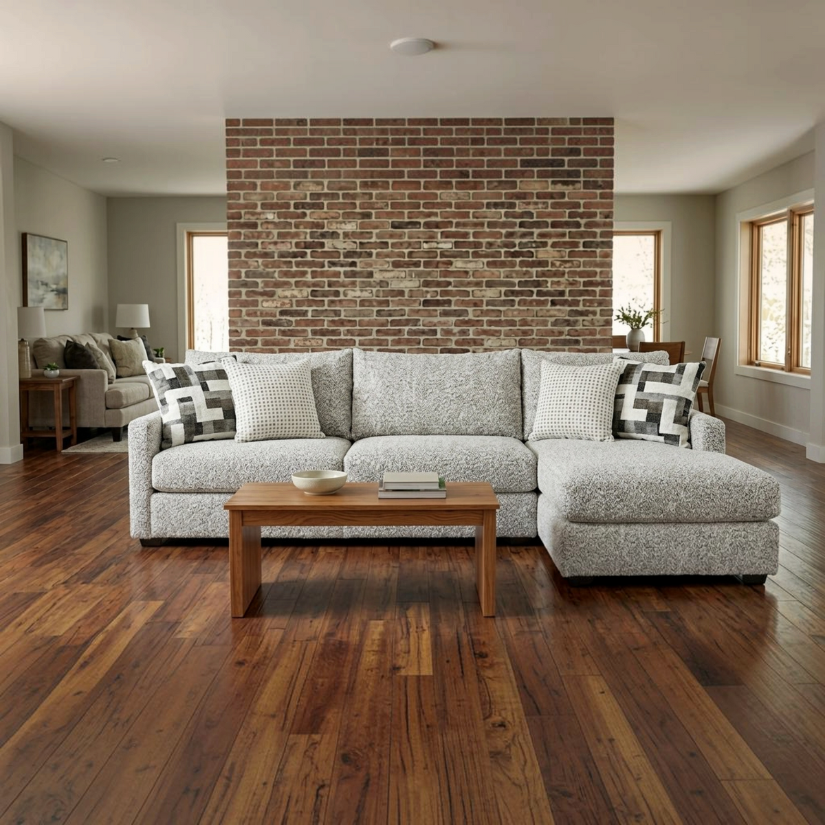 Sunset Sectionals Anson Tatum River Rock oversized sectional with textured grey fabric and patterned accent pillows