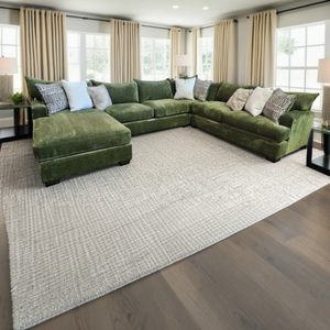 Sunset Sectionals Ivy oversized green U-shaped sectional with reversible cushions in a bright, modern living room.